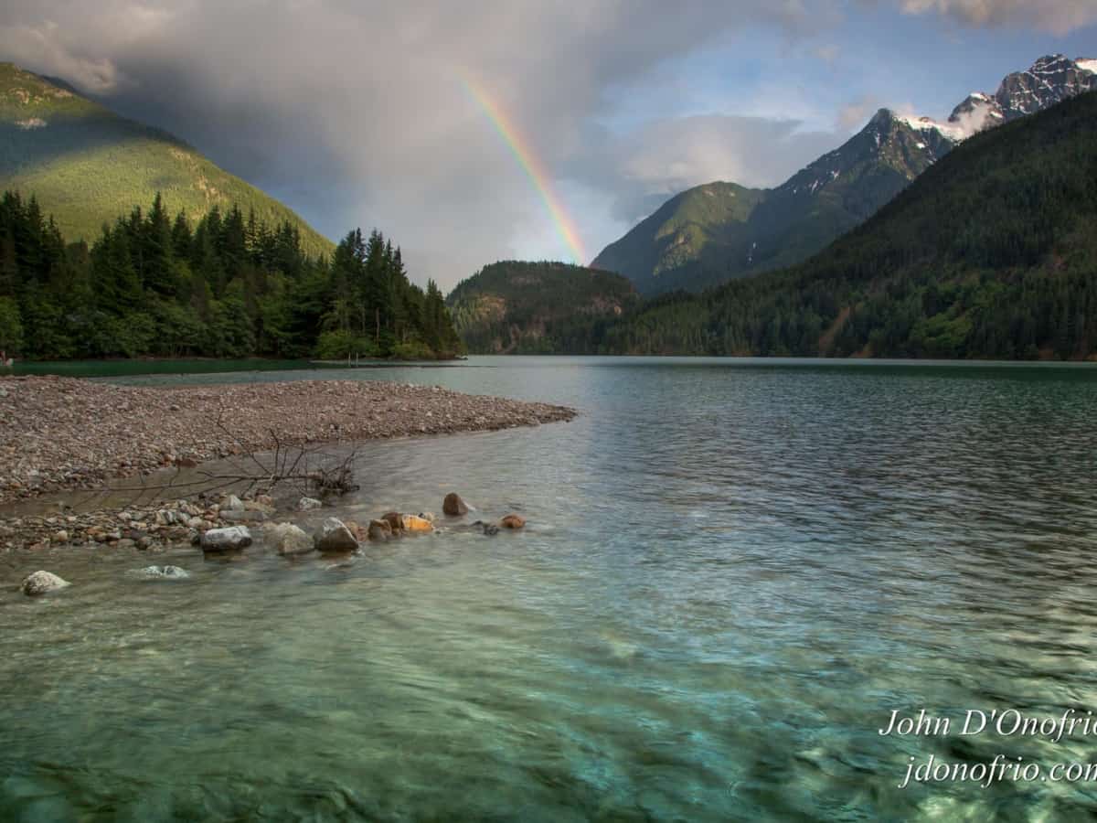 Rainbow over mountains with Lake Diablo in the foreground
