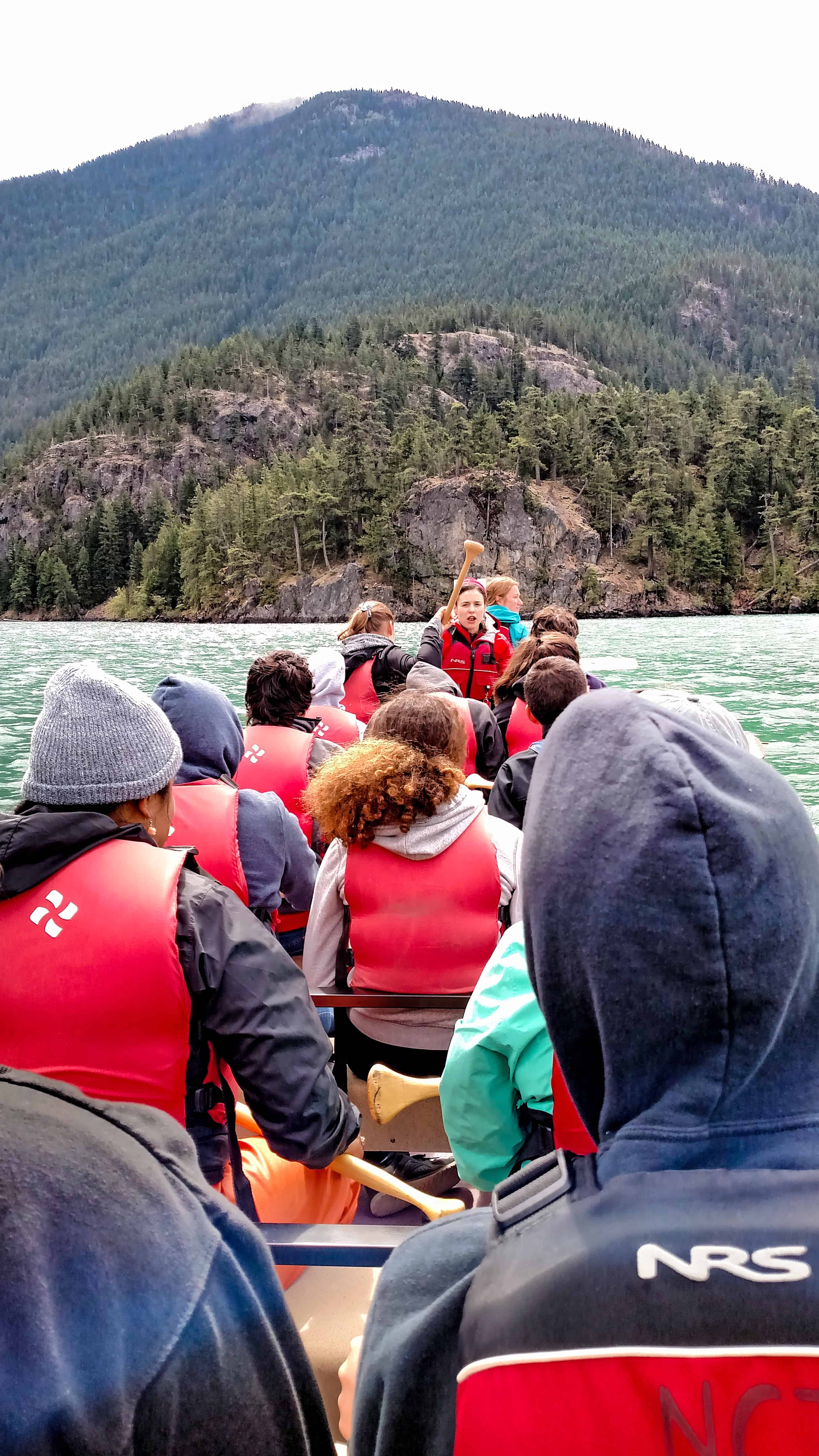 Youth on a canoe with instructor leading on Diablo Lake